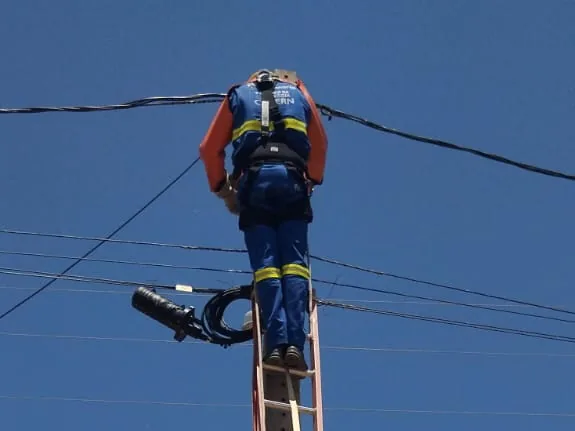 Profissional com cinturão de segurança em atividade em altura